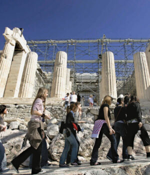 Tourists walk atop the ancient Acropolis in Athens